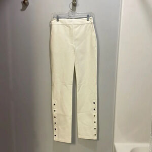 10 Crosby Derek Lam woman’s cream slacks with silver buttons on the bottom